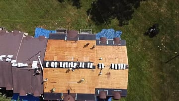 aerial shot of new roof replacement in progress on multiple apartment buildings